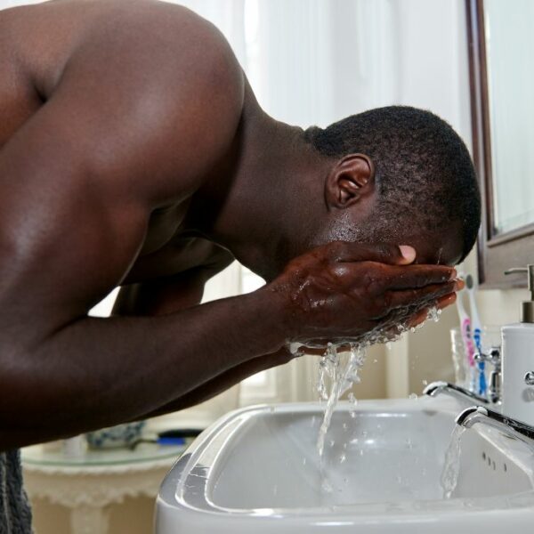 black man washing his face