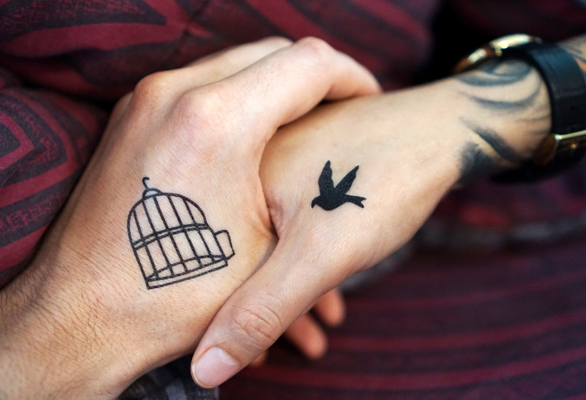 man and woman with complementary tattoos